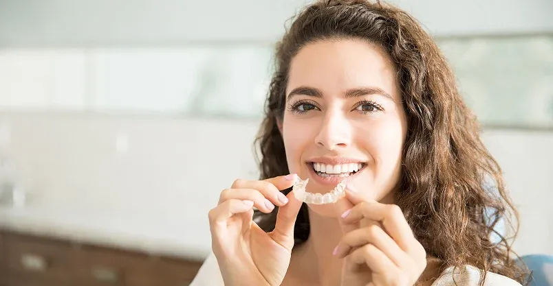 Happy patient pointing to smile